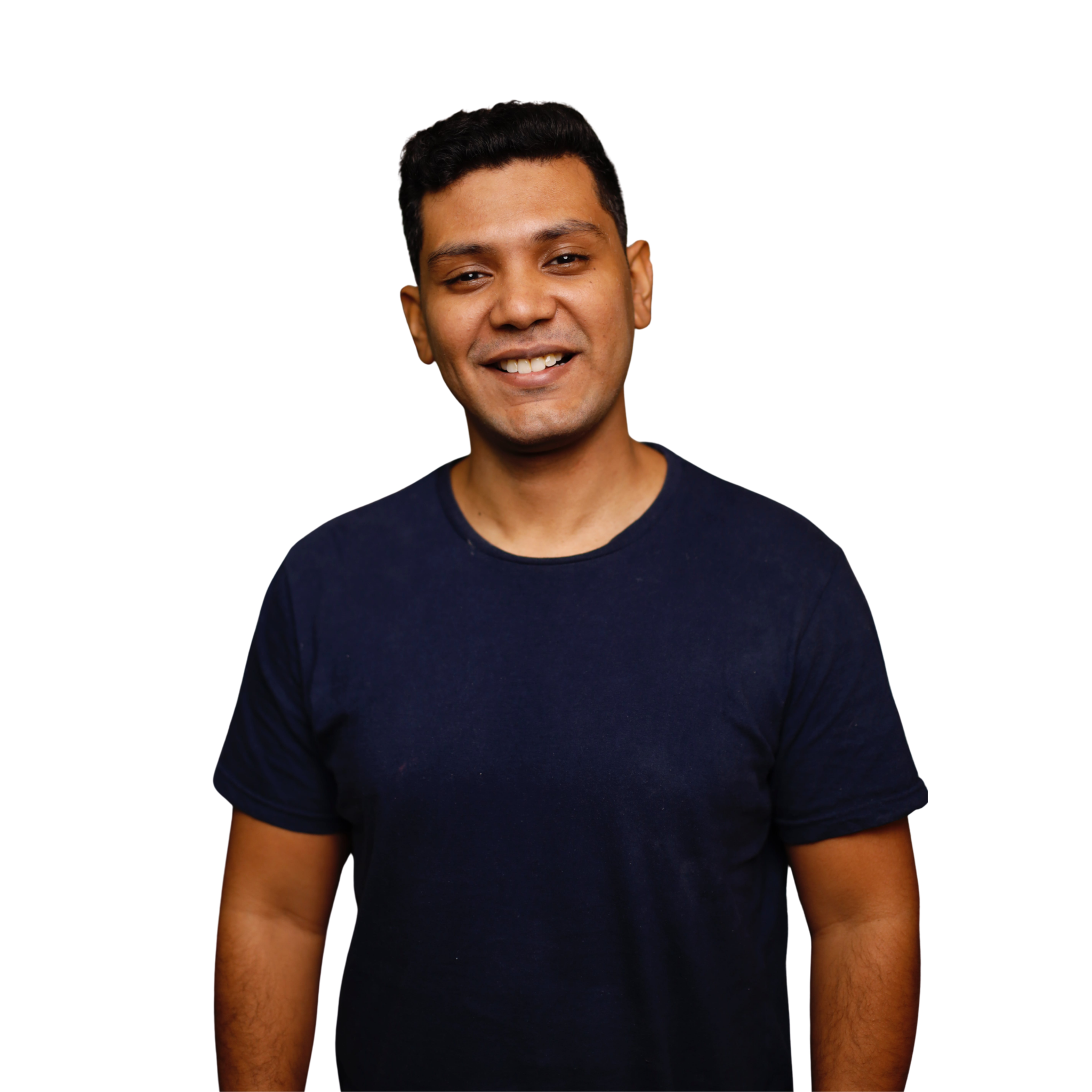 Smiling man wearing a plain navy short sleeve t-shirt, standing against a light background