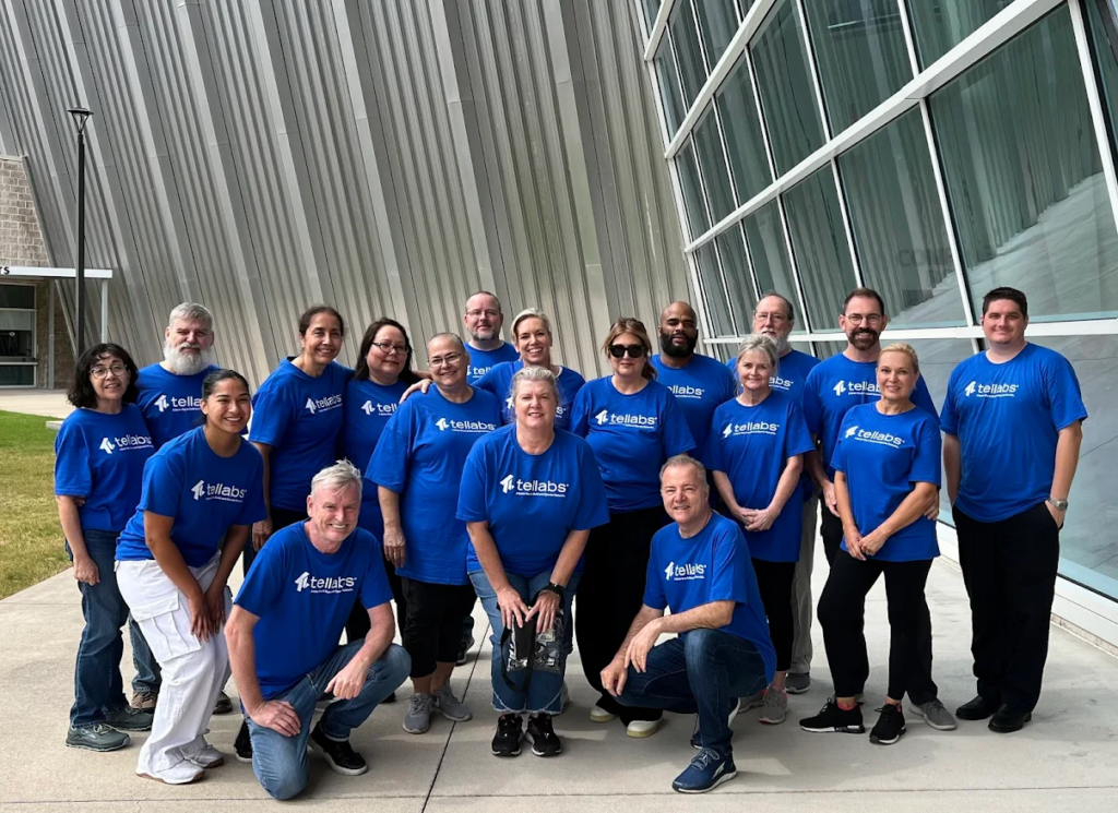 Employees wearing matching branded company shirts for a corporate team event.